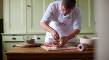 Thumbnail of Chef preparing joint of meat and stuffing